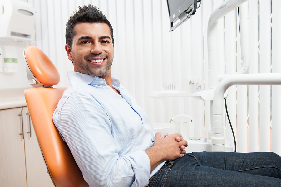 man smiling in dentist chair Lee's Summit, MO crowns and bridges